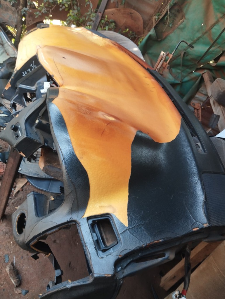 Cracked peeling car dashboard awaiting restoration at Bungoma Seatcovers Ventures workshop
