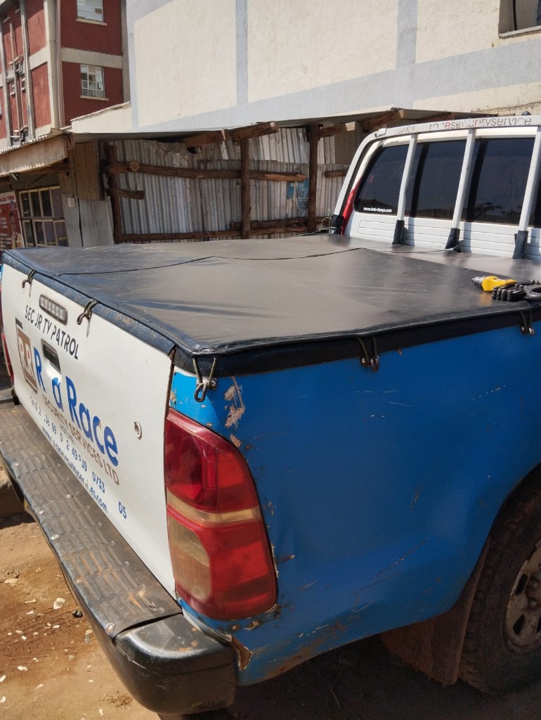 Black vinyl flat bed tonneau cover installed on a pickup truck by Bungoma Seatcovers Ventures