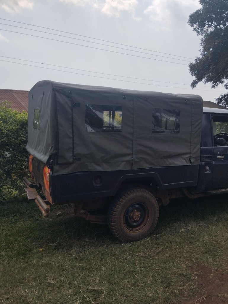 Custom olive green canvas canopy enclosure fitted on a pickup truck bed by Bungoma Seatcovers Ventures