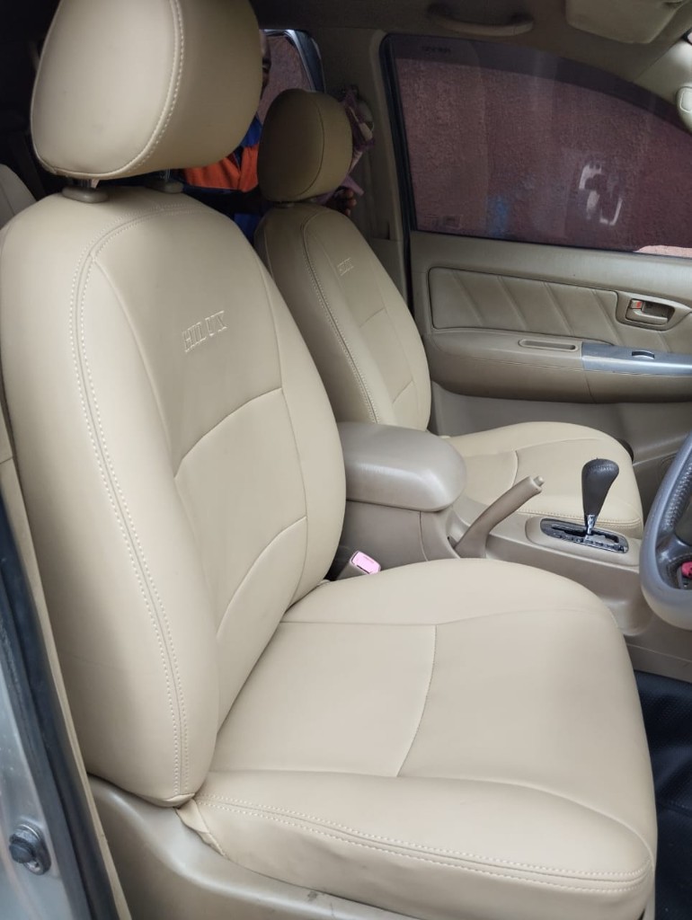 Toyota Hilux beige leatherette seat covers with embroidered HILUX logo and matching door trim by Bungoma Seatcovers Ventures