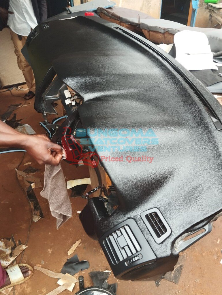 Freshly wrapped black textured dashboard being finished at Bungoma Seatcovers Ventures workshop