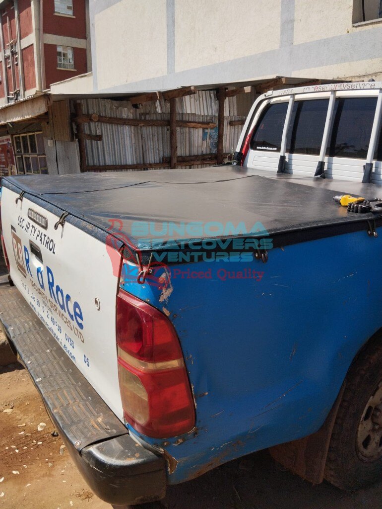 Black vinyl flat bed tonneau cover installed on a pickup truck by Bungoma Seatcovers Ventures