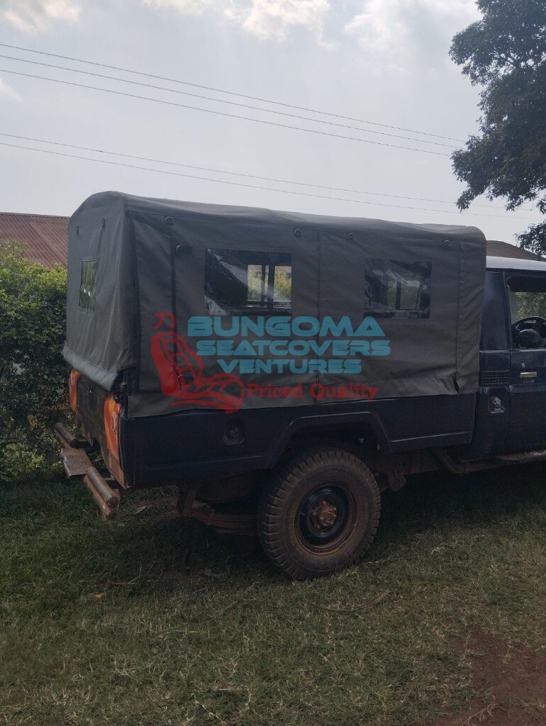 Custom olive green canvas canopy enclosure fitted on a pickup truck bed by Bungoma Seatcovers Ventures